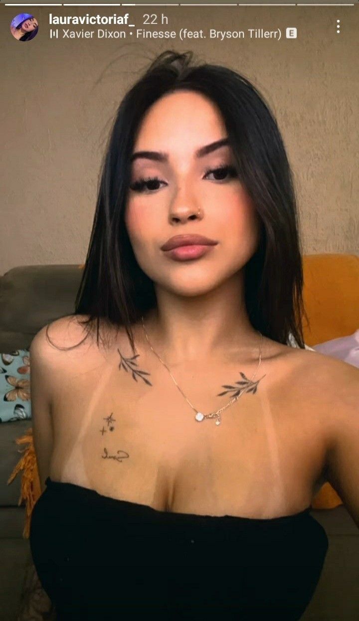 Client displaying delicate collarbone tattoos, an example of small to medium tattoo sizing that affects overall pricing in Lahore