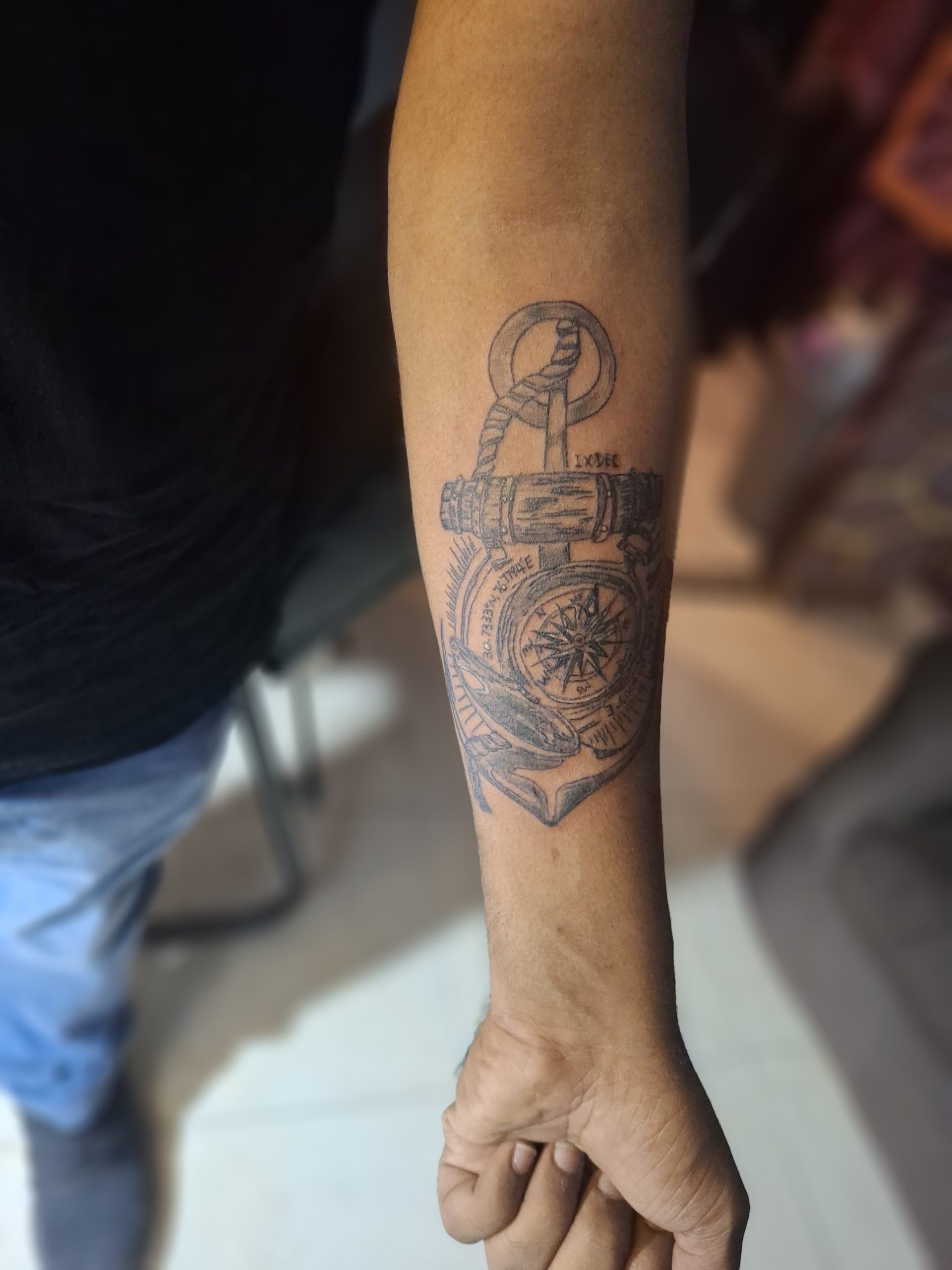 Fine line anchor and compass tattoo done at Devil Tattoo Lahore DHA Phase 7