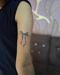 Minimal bow tattoo on arm Devil Tattoo Lahore