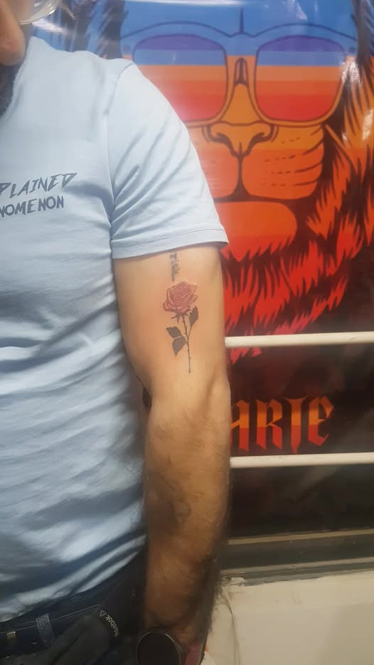 Colour rose tattoo on forearm by Devil Tattoo Lahore artist