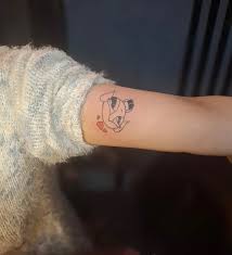 Delicate fine-line tattoo created by a female tattoo artist in Lahore, showcasing detailed custom ink work