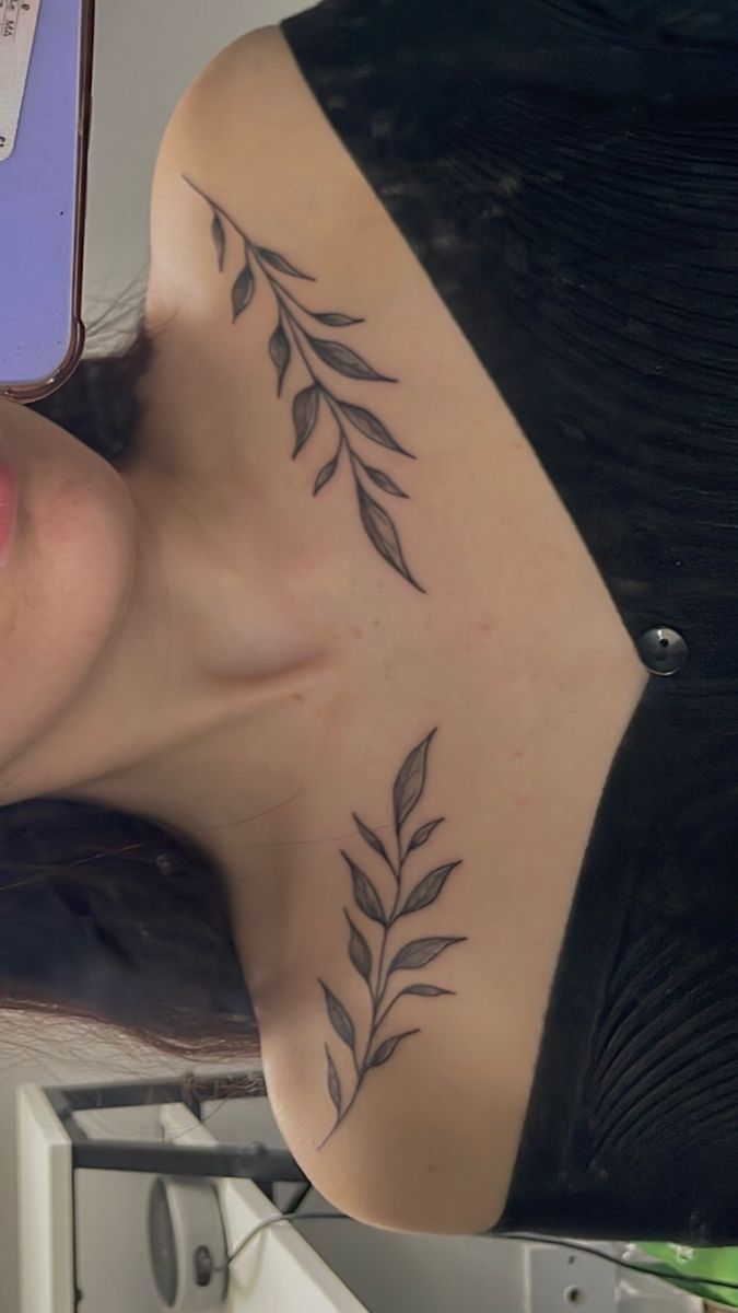 Fine line leaf branch tattoo along the collarbone illustrating delicate needlework standards used in medical tattoo procedures