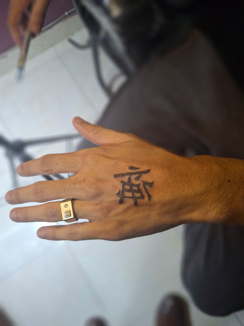 Bold hand tattoo example showing popular tattoo styles available in Lahore
