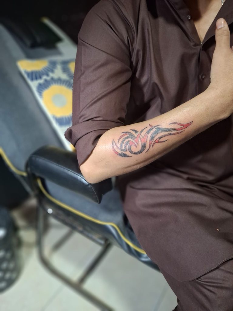 Bold tribal blackwork tattoo, a style often used for tattoo cover-ups at Devil Art Studio, Lahore