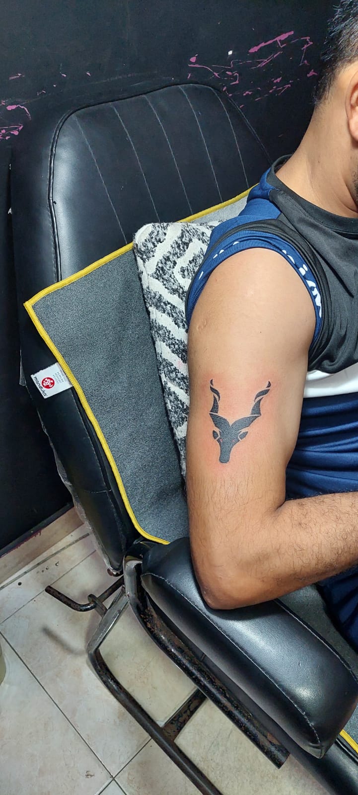 Premium tattoo studio of Lahore showing a minimalist animal head outline tattoo