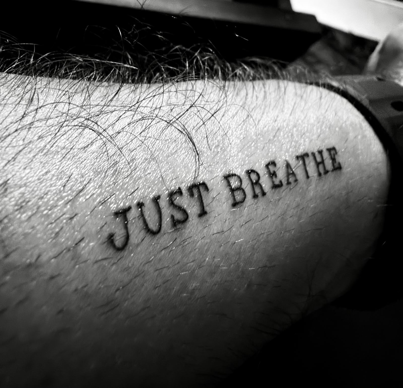 Minimal Just Breathe script tattoo completed during a private, appointment-only session at Devil Art Studio in Lahore