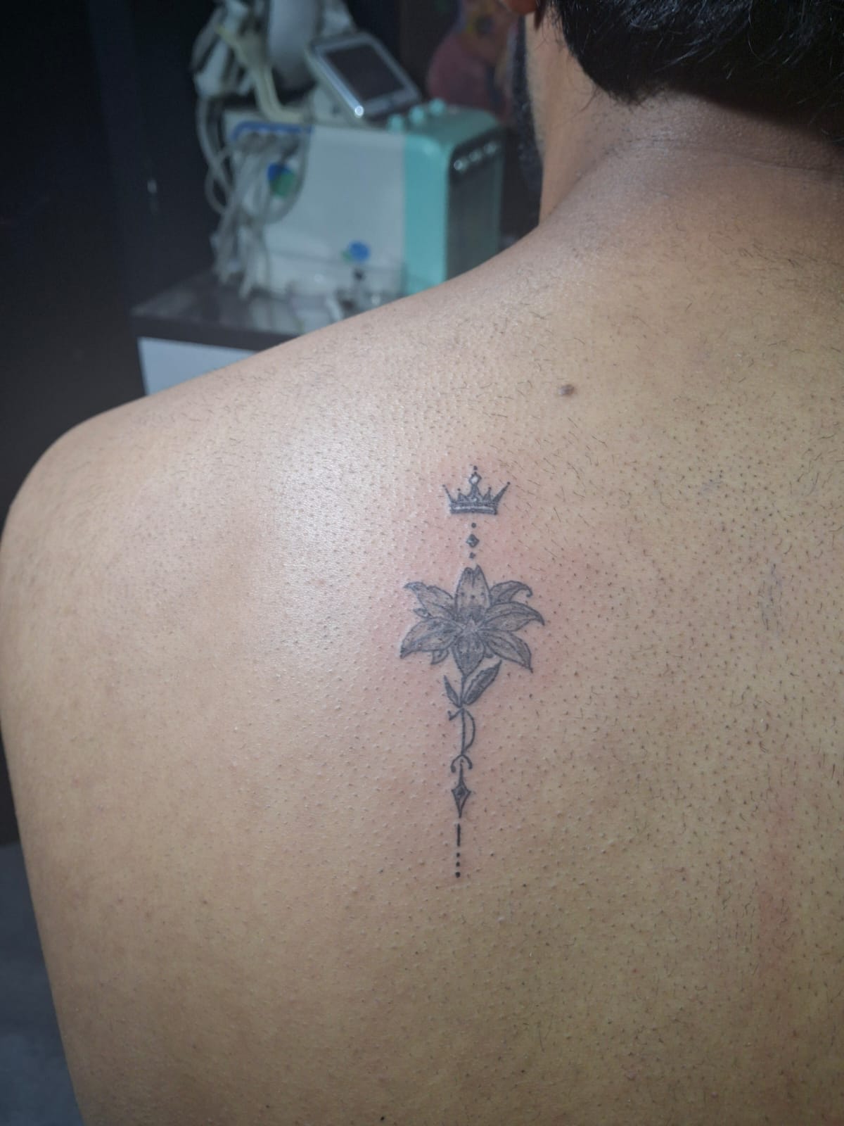 Minimalist flower and crown back tattoo, elite custom design from Devil Art Studio Lahore