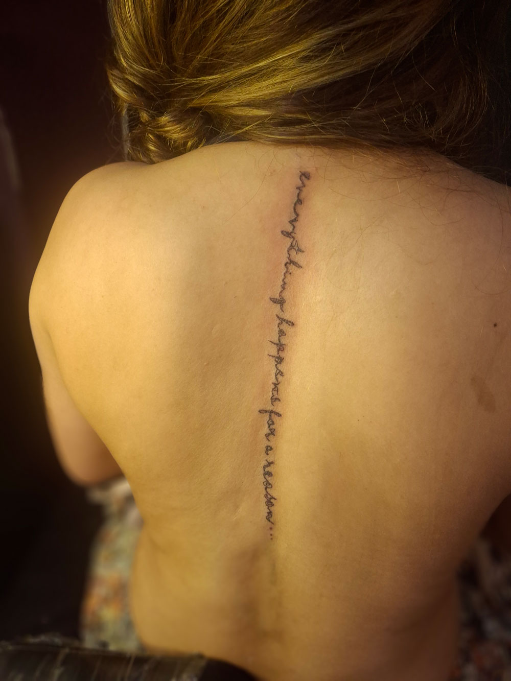 Tattoo studio at MM Alam Road Lahore showing a fine line spine script tattoo