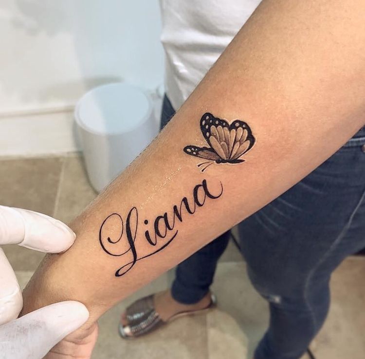 Liana name tattoo with butterfly on forearm by Devil Art Studio Lahore