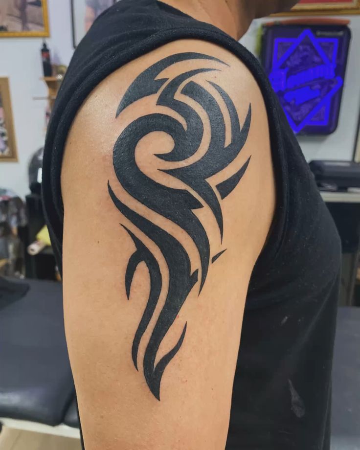 Flowing tribal wave tattoo on shoulder by Devil Art Studio Lahore