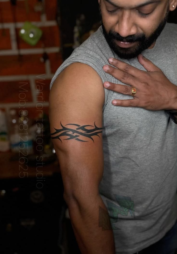Bold tribal armband tattoo by Devil Art Studio Lahore