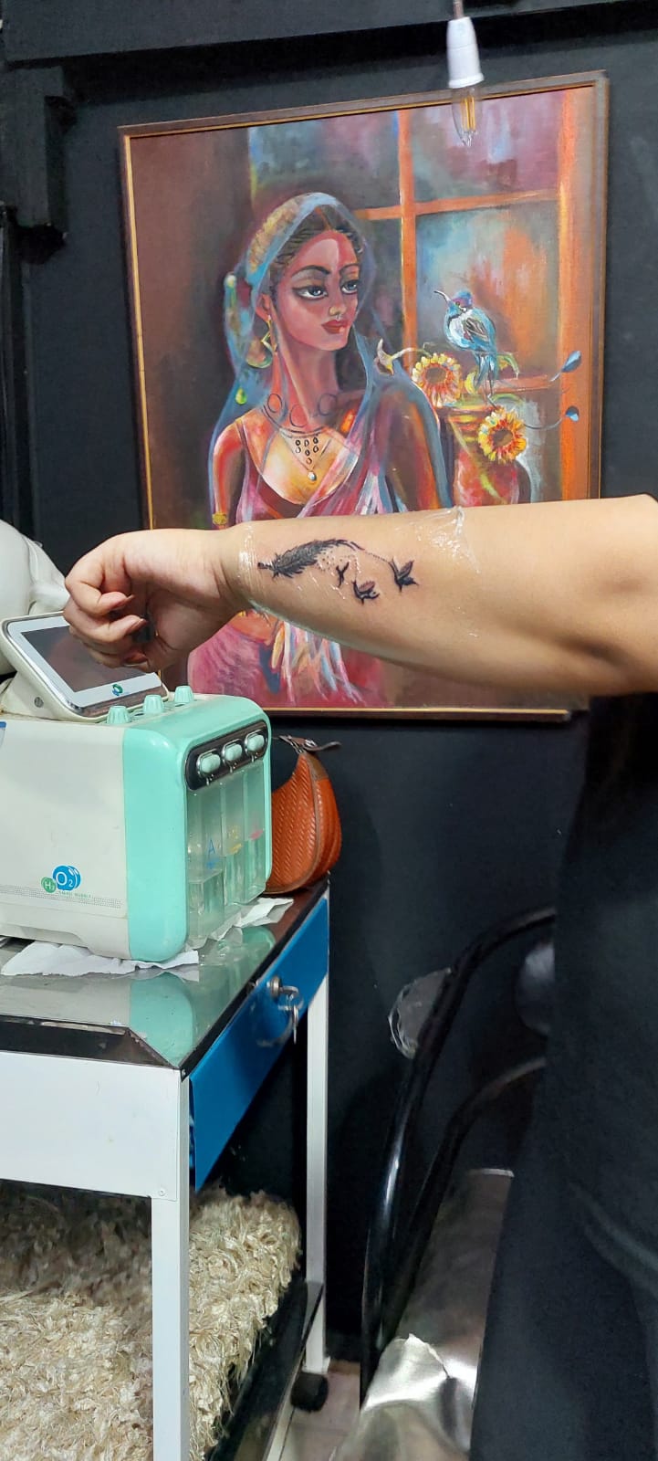 Fine line feather and birds tattoo being made at Devil Art Studio Lahore